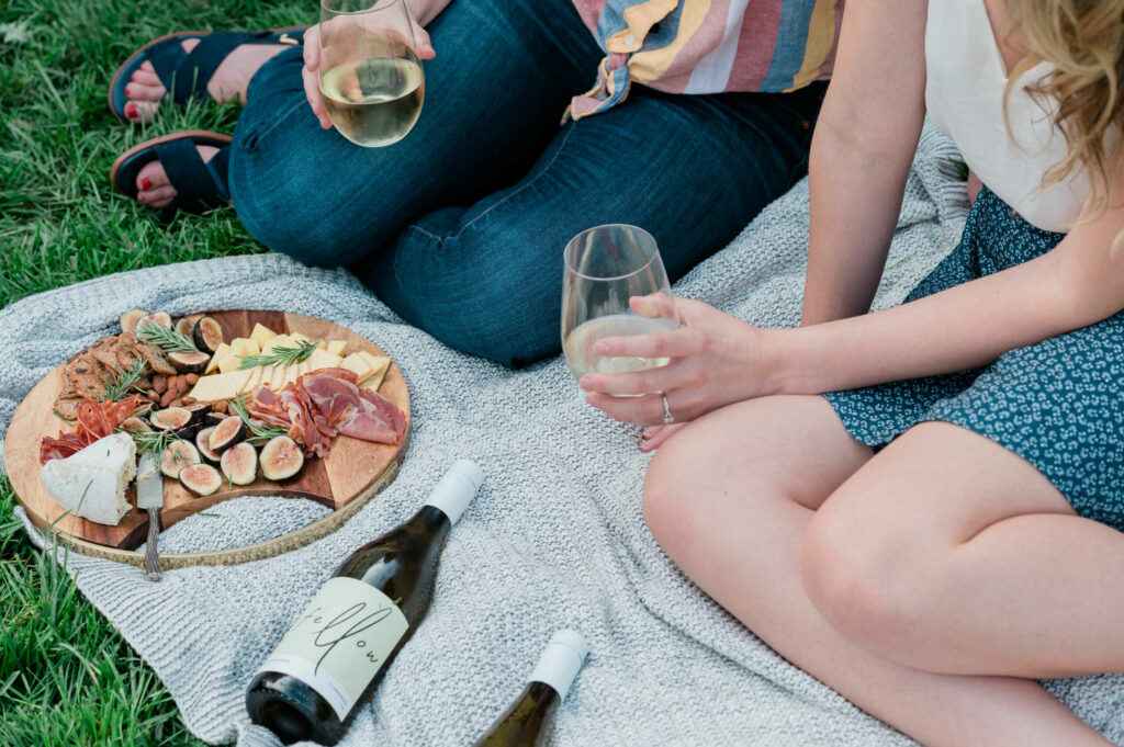 man and woman picnicking with fellow wines