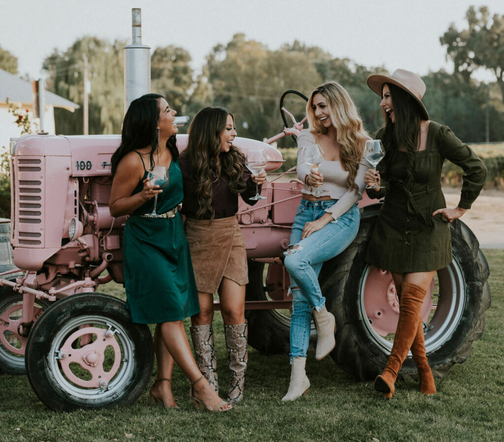 women gathered around pink tractor