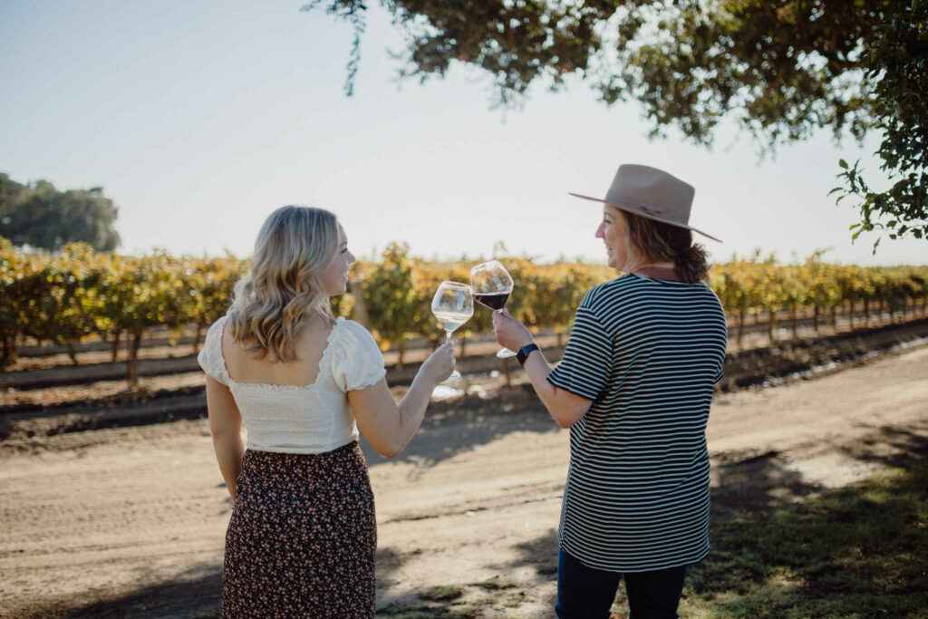 two women toasting at vineyard